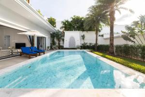 a swimming pool in the backyard of a house at Menara - 3 BR Private Pool Villa - Moroccan Inspired - Bangtao Beach in Phuket