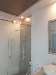 uma casa de banho com um chuveiro, um WC e um lavatório. em khách sạn Quốc Tế em Cà Mau
