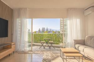 a living room with a couch and a large window at Buenti Apartments Beach Beautiful view in Marbella