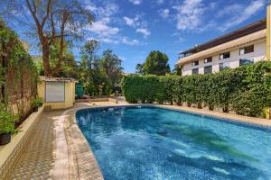 a swimming pool in front of a building at Krushnai Resort in Lonavala