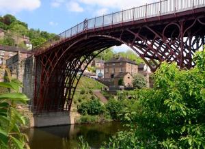 a bridge over a river in a town with buildings at Mount Cottage in Shrewsbury