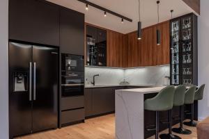 a kitchen with a refrigerator and a counter at Villa 4A Visoko in Visoko