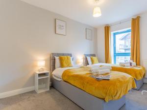 a bedroom with two beds and a window at Contractor Accommodation Specialist, 3 bedroom house with FREE Parking, Wifi & Netflix! in Milton Keynes