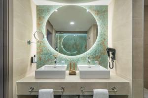 a bathroom with two sinks and a mirror at Occidental Puerto Banús in Marbella