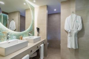 a bathroom with a sink and a mirror at Occidental Puerto Banús in Marbella