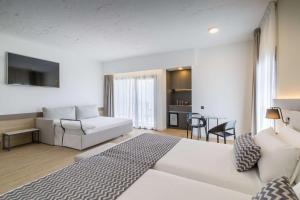 a living room with a white bed and a couch at Occidental Puerto Banús in Marbella