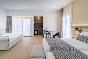 a hotel room with two beds and a living room at Occidental Puerto Banús in Marbella