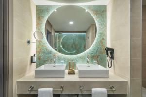 a bathroom with two sinks and a mirror at Occidental Puerto Banús in Marbella