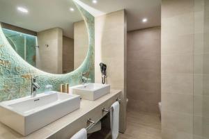 a bathroom with a sink and a mirror at Occidental Puerto Banús in Marbella
