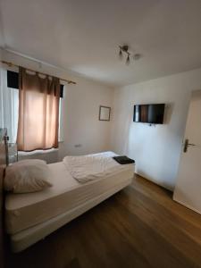 a bedroom with a bed and a window at Pension Seevetal in Seevetal