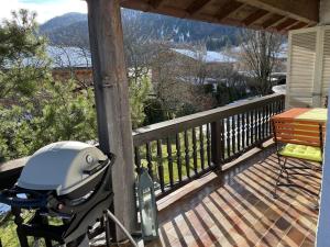 a stroller on a porch with a view of a mountain at Ferienwohnung Rebensburg in Point