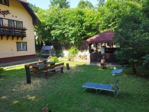 a backyard with a gazebo and a picnic table at Villa Foișor in Buşteni