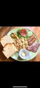 a plate of food on a wooden table at kohkoodfarmstay in Ban Ao Yai