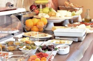 bufet z wieloma różnymi rodzajami żywności na stole w obiekcie Artemisia Resort w mieście Puntarazzi