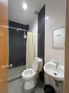 a bathroom with a toilet and a sink at Argao Seabreeze Hotel powered by Cocotel in Argao