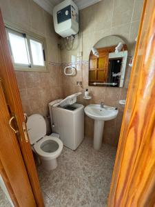 a bathroom with a toilet and a sink and a mirror at Casa Pepa in Puerto de Mogán