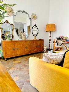 a living room with a large mirror and a couch at Casa di Lo in Ciampino