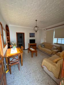 a living room with a couch and a table at Casa Pepa in Puerto de Mogán +2 photos