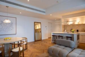 a kitchen and living room with a table and chairs at Luxe CL in Colombo