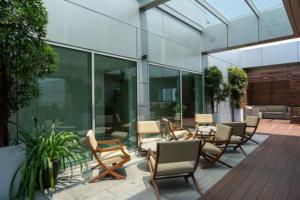 a patio with chairs and tables on a building at Luxe CL in Colombo