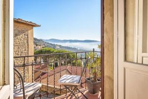 d'un balcon avec une table et des chaises et une vue. dans l'établissement Casa delle Rose - Together in Tuscany, à Cortone