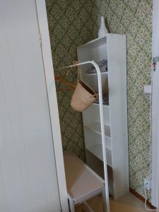 a room with a shelf and a ladder at Private Room in Pink House in Pajala