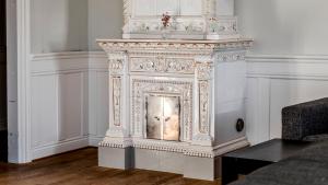 an ornate fireplace in the corner of a room at Clarion Collection Hotel Post in Oskarshamn