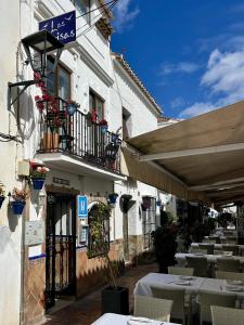 a restaurant with tables and chairs and a building at Las Brisas Estepona in Estepona