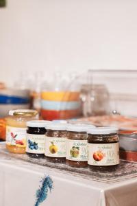 a row of jars of food sitting on a counter at Mare DiVino in Porto Recanati