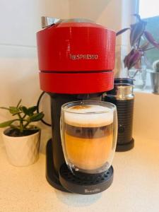 a red mixer sitting on a counter with a cup of coffee at 'Your Place on Davidson' in Mount Isa