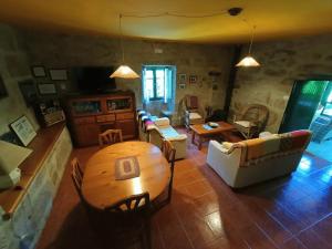 sala de estar con mesa de madera y sillas en Casa Uma Turismo Rural, en Taboeja