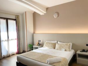 a bedroom with a bed with a clock on the wall at La Bergamina Hotel & Restaurant in Arcore