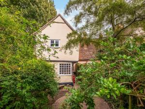 a house seen through the trees at Dukes Lodge in Kersey