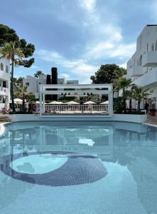 a large swimming pool with a white fence around it at Prinsotel Alba & Spa in Cala d´Or
