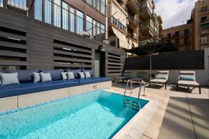 a swimming pool in the middle of a building at Catalonia Gran Via BCN in Barcelona