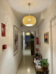 a hallway with a room with a table and a chandelier at Las Brisas Estepona in Estepona