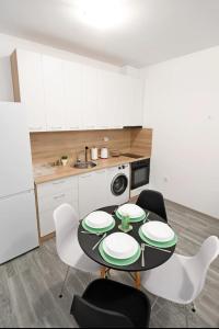 a kitchen with a black table and chairs and a sink at Lazy loft in Sofia