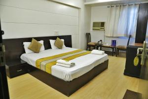 a bedroom with a large bed with towels on it at Hotel Sweet Home Near New Delhi Railway Station in New Delhi