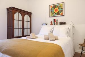 ein Schlafzimmer mit einem großen Bett mit zwei Kissen darauf in der Unterkunft Olha o Mar in Nazaré