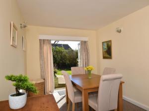 a dining room with a table and chairs and a window at 2 bed in Bude 58818 in Bude