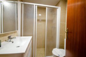 a bathroom with a shower with a sink and a toilet at GEMELOS 10 Levante Beach in Benidorm