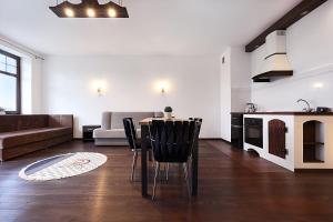 a kitchen and living room with a table and chairs at apartament 34 in Szczecinek