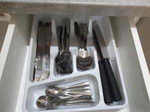 a drawer filled with silver utensils in a sink at Ubytovna Moravan Brno in Brno