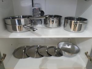 three pots and pans on a shelf in a kitchen at Ubytovna Moravan Brno in Brno +35 photos