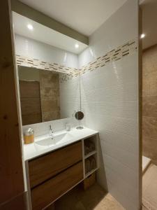 a bathroom with a sink and a mirror at En Provence chez Valérie in Cavaillon +8 photos