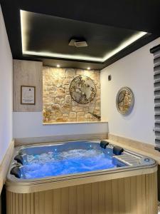 a hot tub with blue water in a room at Olimpiko in Vrdnik