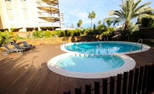 a swimming pool in the middle of a building at Villa Pepita in Benicàssim