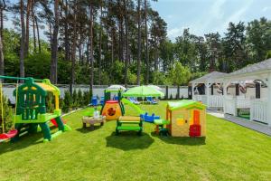 a group of play structures on the grass at VivaLaMer in Pobierowo