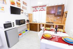 a kitchen with a table with plates on it at Baglioni Vatican House in Rome +13 photos