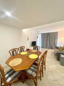 a dining room with a wooden table and chairs at Flat Luxuoso Praia da Oura in Albufeira